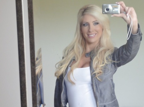 Platinum blonde beauty Tasha Reign taking selfies while getting naked