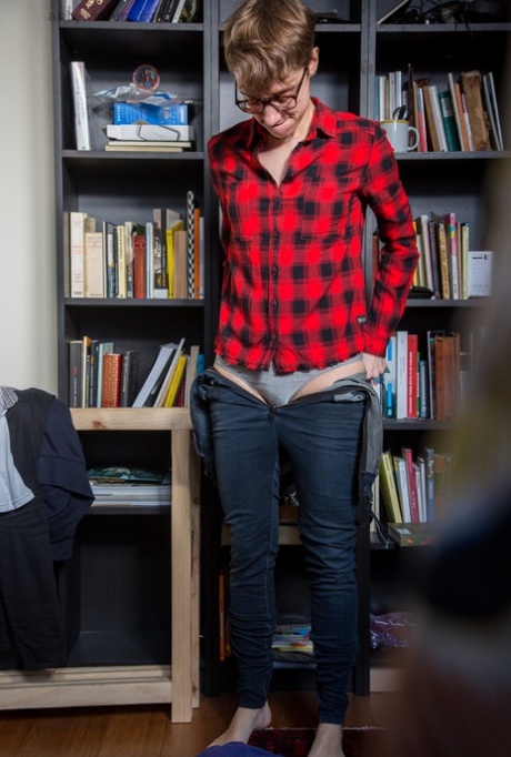 Skinny amateur Gretchen dresses herself among library stacks