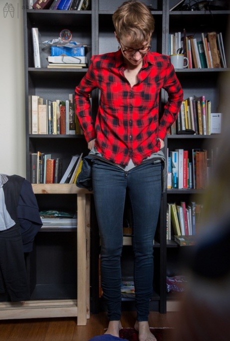 Skinny amateur Gretchen dresses herself among library stacks