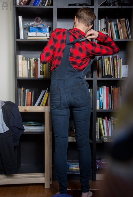 Skinny amateur Gretchen dresses herself among library stacks
