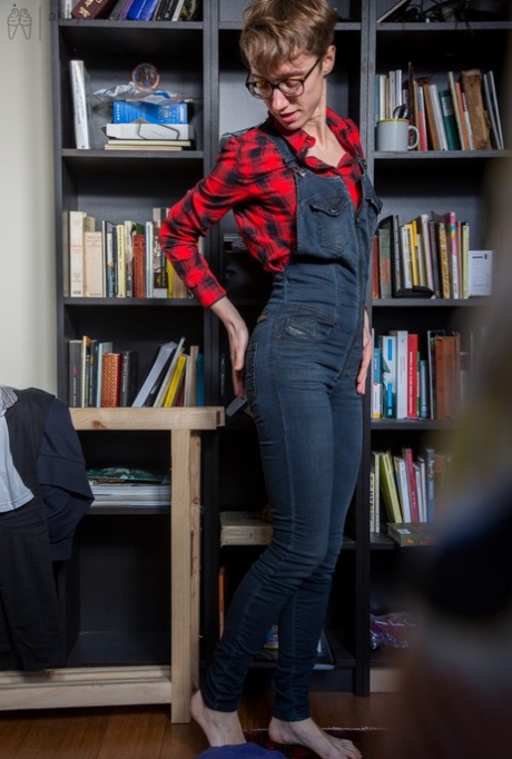 Skinny amateur Gretchen dresses herself among library stacks