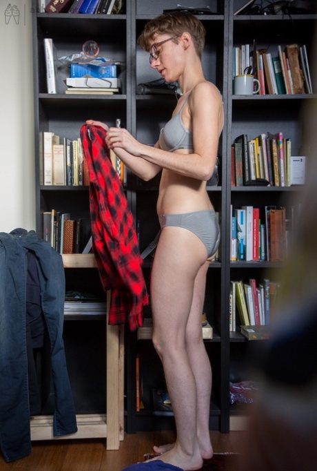 Skinny amateur Gretchen dresses herself among library stacks