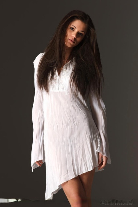 Beautiful teen model Caprice A displaying great legs while stripping naked