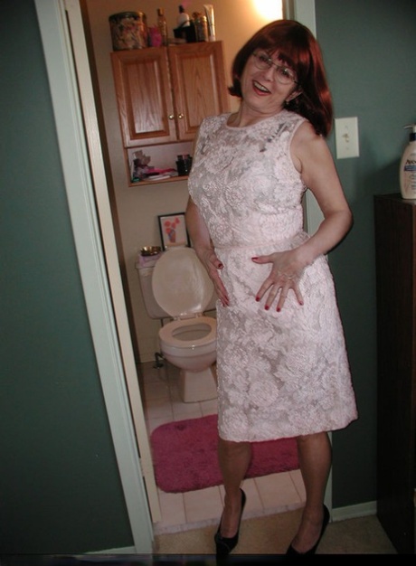 Mature mom Miss Abigail shows her hairy pussy while pissing on the toilet