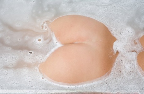 Dirty blonde model Gina displays her nice ass as she gets in a bathtub