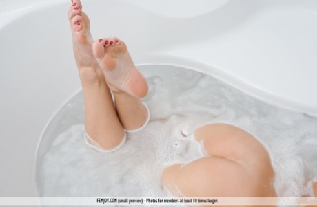 Dirty blonde model Gina displays her nice ass as she gets in a bathtub