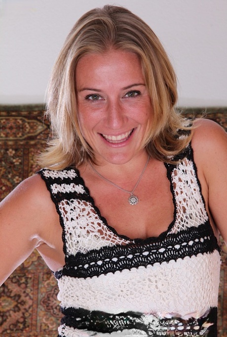 Mature blonde Sky squats in heels after a slow striptease on a landing