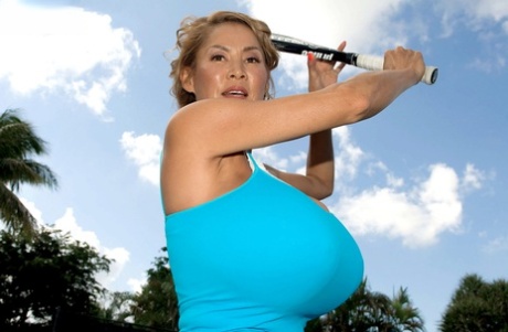 Mature South Korean pornstar Minka teases with her rack while playing tennis