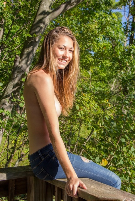 Amateur chick Becca Clark uncovers her nice tits out in the backyard