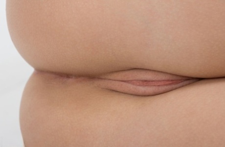 Smiley teen Tutty shows off her nipples and shaved pink beaver in hot closeup