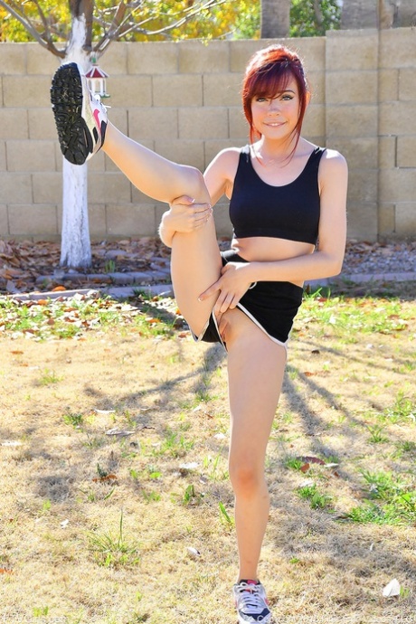 Athletic chick takes off her shorts and sports bra to do yoga in the nude