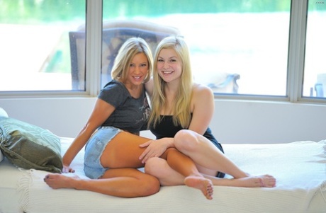 Lesbian blonde Danielle Delaunay fists pussy of tanned girl with big tits