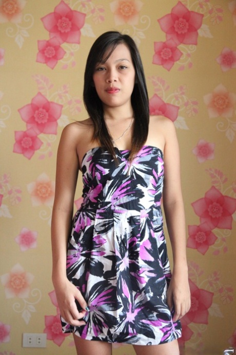 Skinny Asian spinner Lynn displays her small tits and innie pussy on the bed