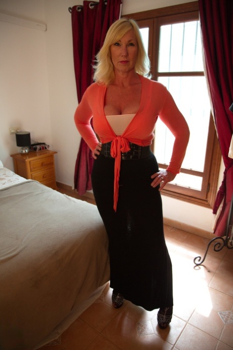 Mature blonde Melody Charm unveils her big naturals prior to masturbating