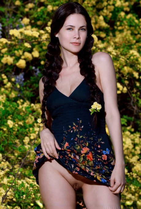 Sexy teen Martina Mink gets undressed in braided pigtails by flowering bushes
