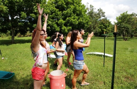 Pretty naked lesbians are standing naked and showing their bodies outdoor