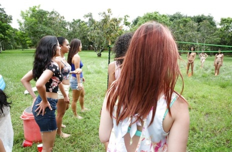 Pretty naked lesbians are standing naked and showing their bodies outdoor