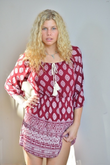 Natural blonde with wavy hair shows off her flexibility while doing yoga