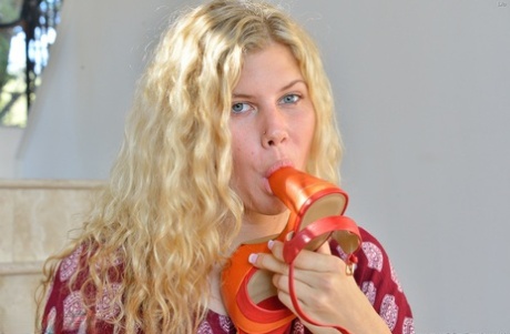 Natural blonde with wavy hair shows off her flexibility while doing yoga