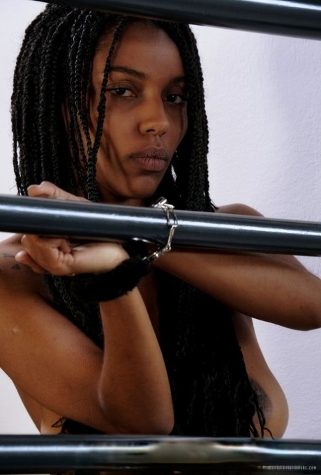 Naked black teen Samantha A attends to her horny pussy while cuffed to rails