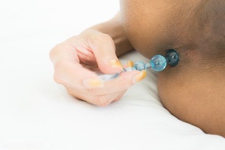 Asian shemale Candy masturbates attired in black over the knee boots