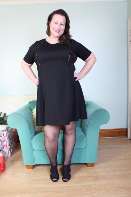 Brunette mom Eva Jayne removes her black dress and flaunts her curves