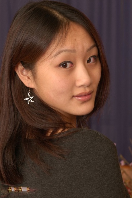 Asian first timer Evelyn spreads her bare legs and labia lips too