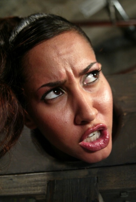 Isis Love finds herself being humiliated in the stocks with a hook in her anus