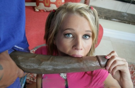 Cute blonde in shorts sucks a big black cock and gets drowned in cum