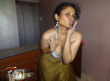 Indian woman lets a boob slip loose from her bra while being a tease