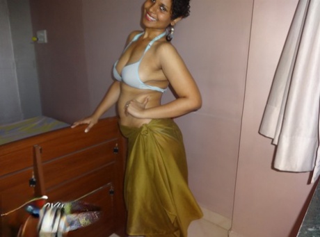 Indian woman lets a boob slip loose from her bra while being a tease