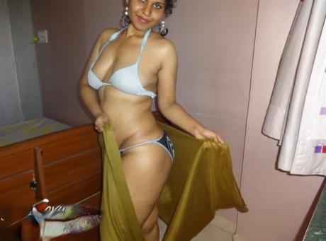 Indian woman lets a boob slip loose from her bra while being a tease