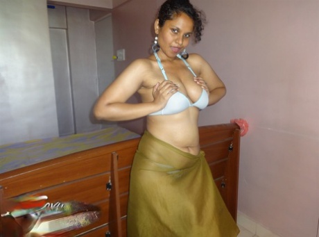 Indian woman lets a boob slip loose from her bra while being a tease