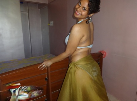 Indian woman lets a boob slip loose from her bra while being a tease