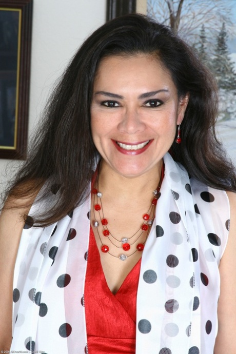 Mature amateur Camille C undressing and massaging her bald pussy