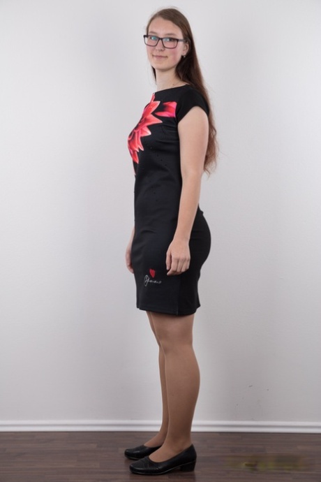 Nerdy teen Katerina stands naked as can be other than her glasses in the nude