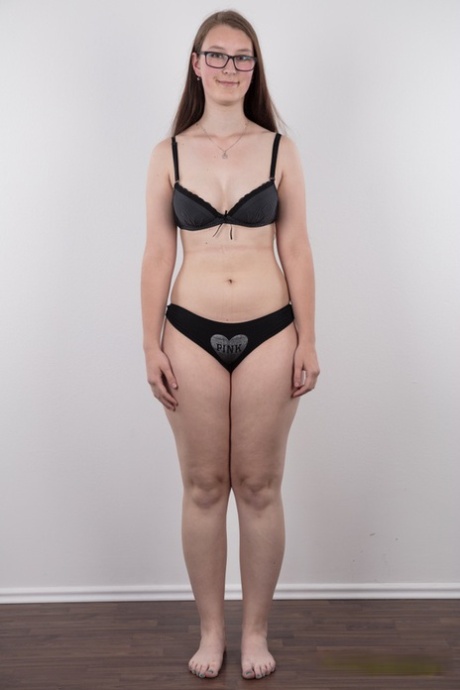 Nerdy teen Katerina stands naked as can be other than her glasses in the nude