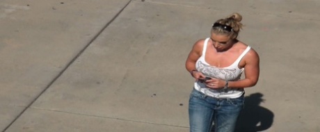 Oblivious busty Karmen Jay's big tits captured in downblouse voyeur photos