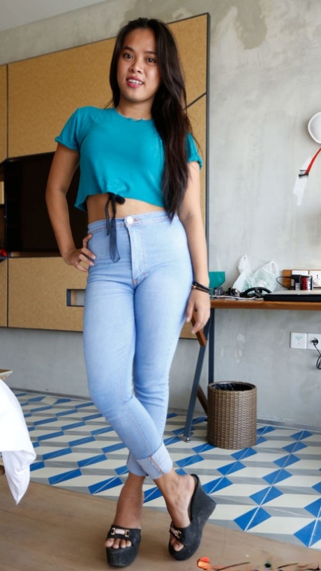 Beautiful Asian teen Nini undresses & shows her big tits before a POV fuck