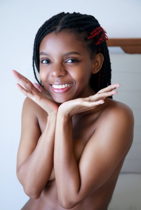 Gorgeous ebony teen Sukki T peels off her thong to get bare naked