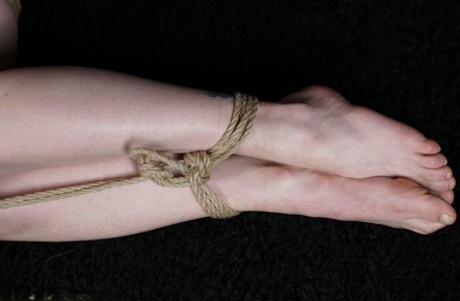 Naked blonde finds her nipples sticking out as she struggles against rope ties