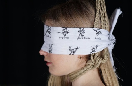 Naked blonde finds her nipples sticking out as she struggles against rope ties