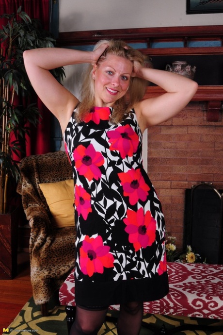 Blonde American housewife strips to black lingerie and stockings