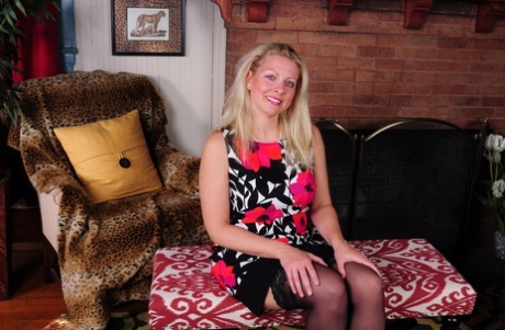 Blonde American housewife strips to black lingerie and stockings