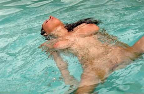 Adorable pornstar Gianna Michaels plays with her big boobs & a toy in the pool