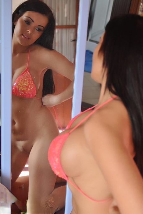 Hot brunette chick Charley Atwell admires her big tits while changing clothes