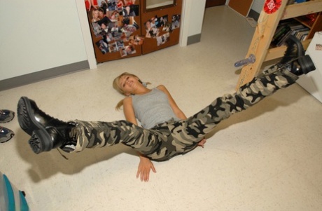 Blonde teen pulls down camo pants before having her tight ass flogged