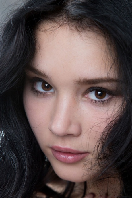 Naked brunette teen Malena Fendi admires her pretty face in the mirror