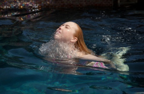 Half-naked babe Samantha Rone stretching and showing her boobs in the pool
