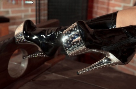 Big titted blonde Dolly Fox poses by herself in long high heeled boots